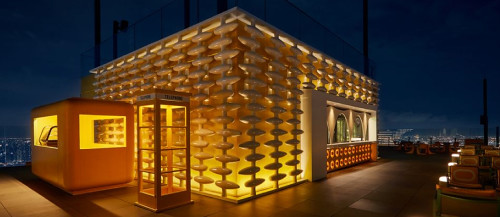 Sky Beach rooftop bar lit up at night above Bangkok