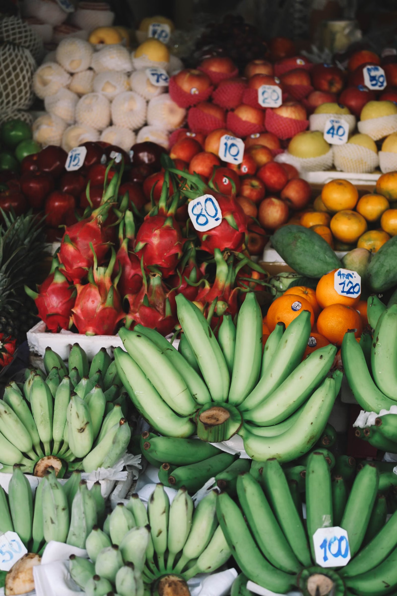 A vibrant Thai market stall piled with fresh produce