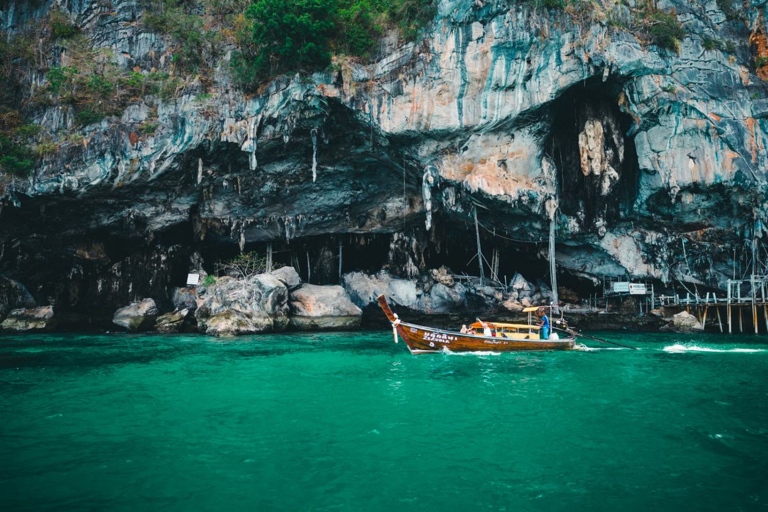 Longtail boat below limestone cliffs off Phuket