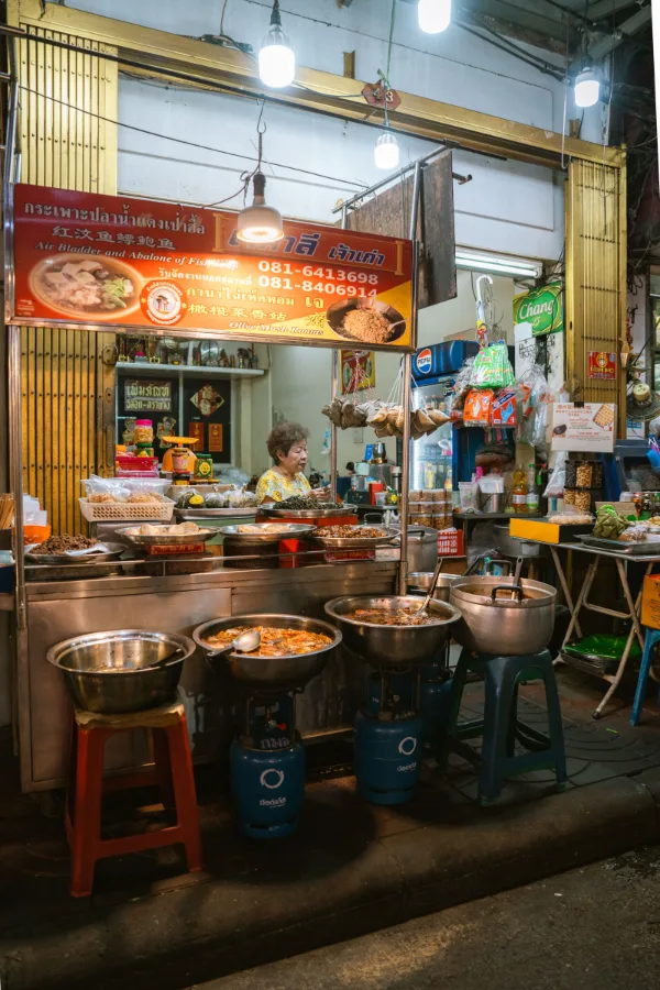 Nighttime street food stall in a Bangkok market