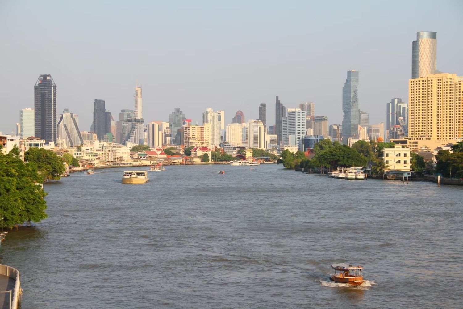 Bangkok skyline along the Chao Phraya River at dusk