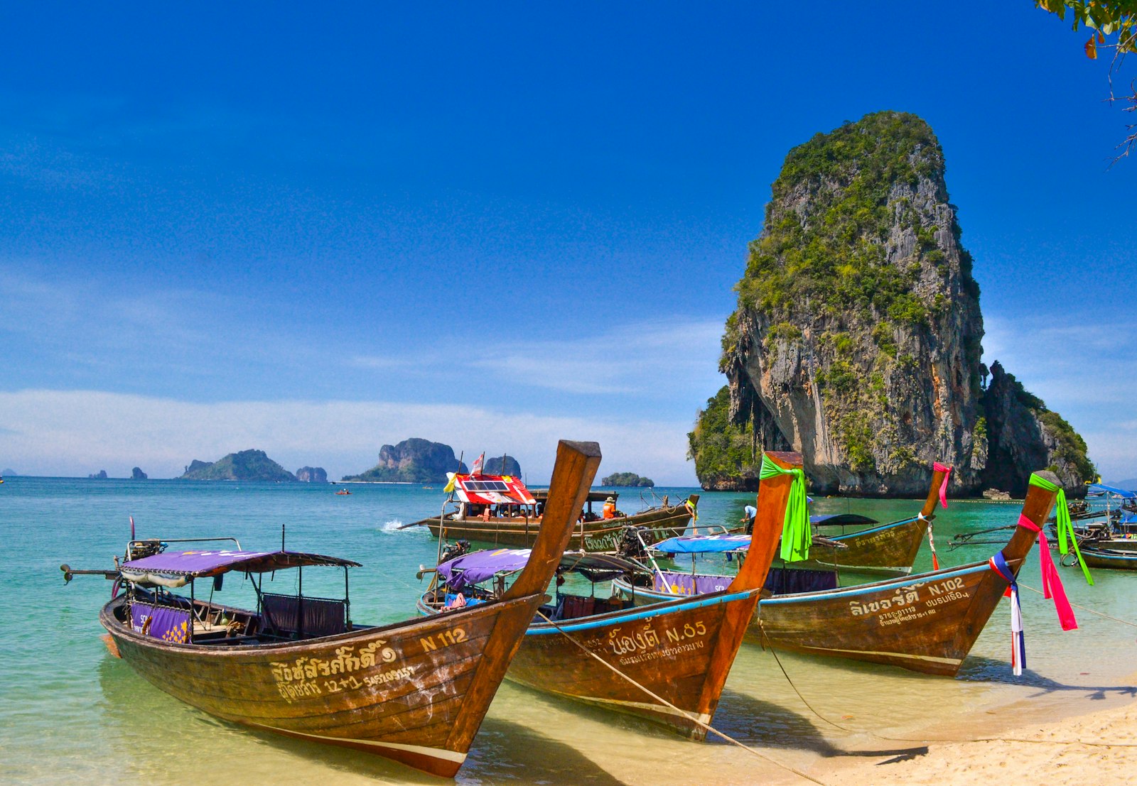 Longtail boats island-hopping among the karsts near Krabi