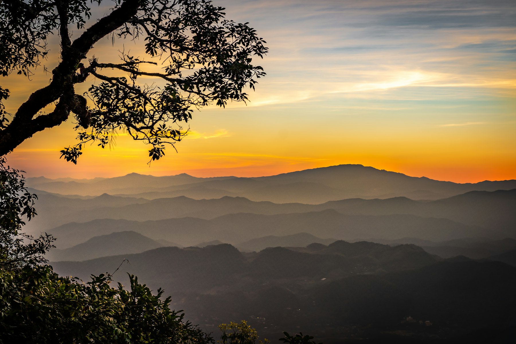 Layered misty mountain ridges of northern Thailand at sunset