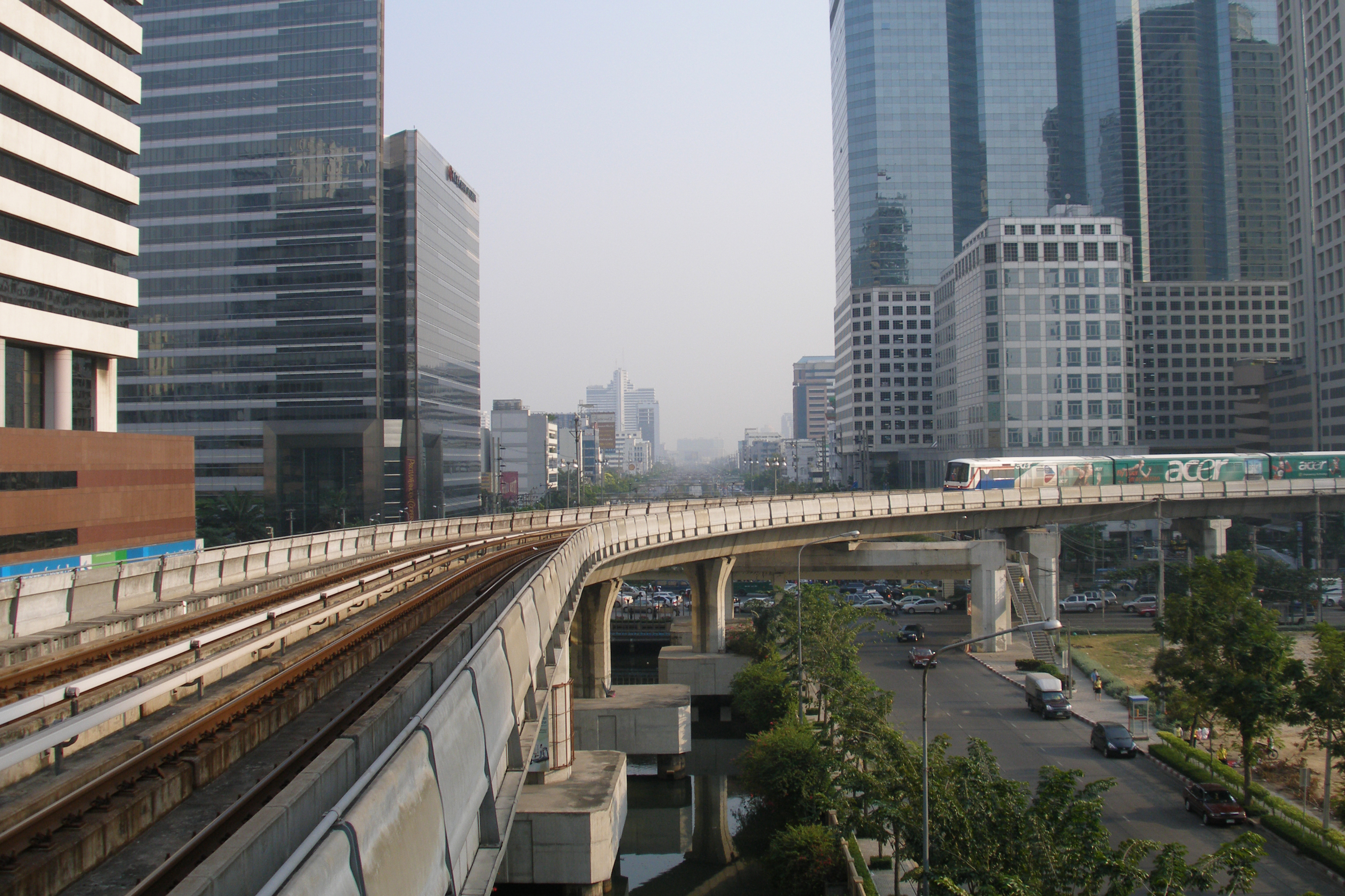 A BTS Skytrain gliding on elevated tracks through Bangkok’s business district