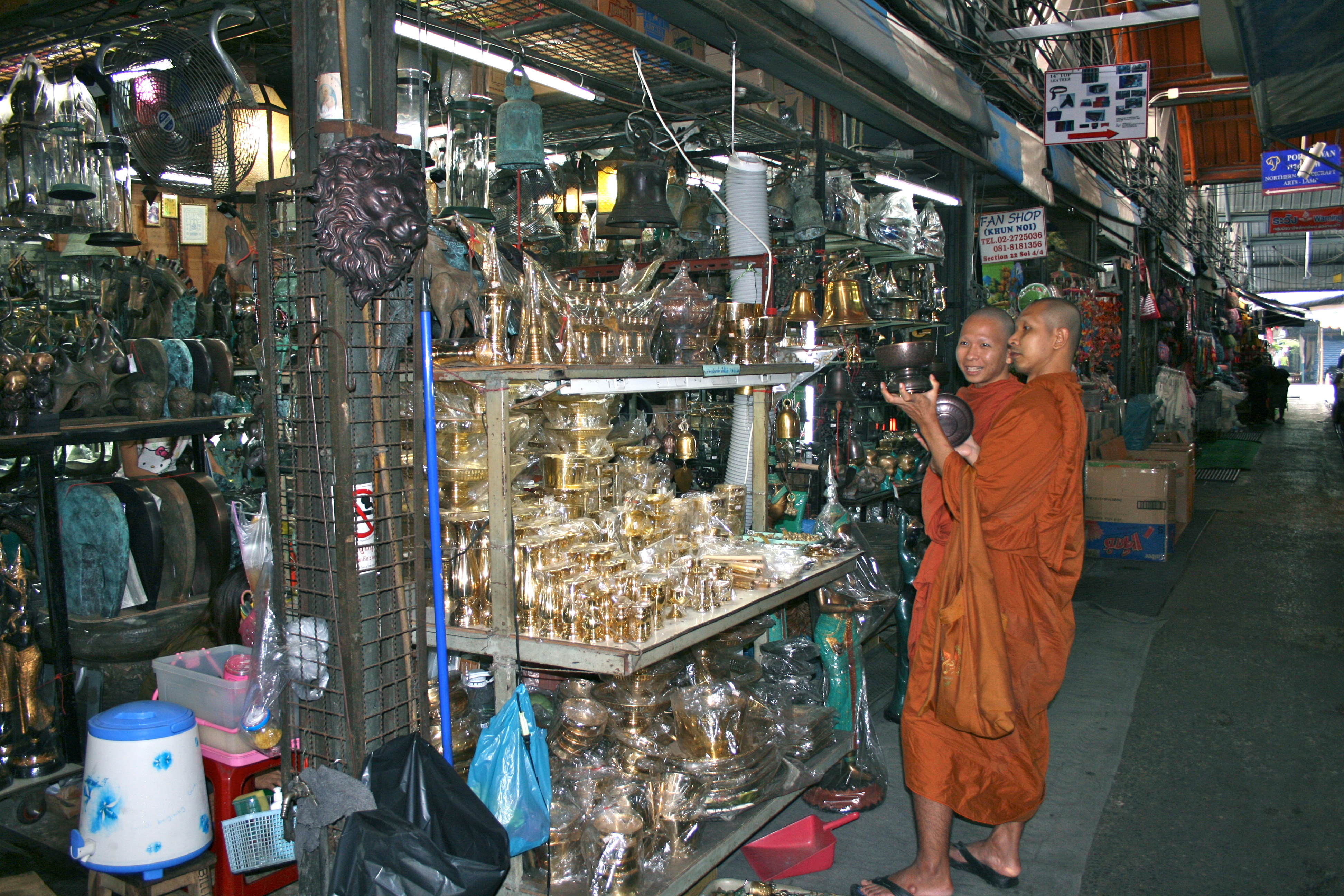 Brassware and handicraft stalls in an aisle of Chatuchak Weekend Market