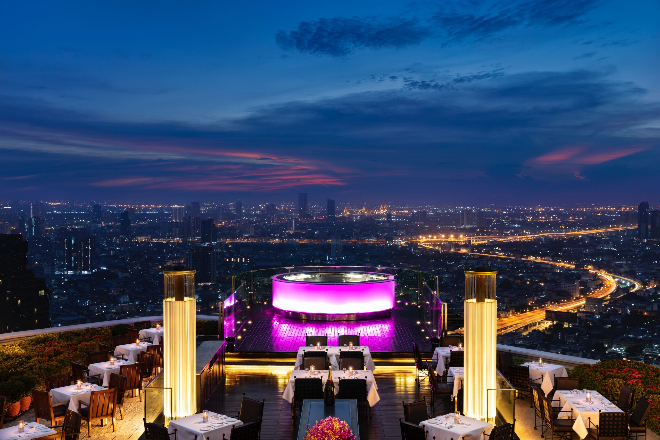 The open-air Sky Bar terrace at lebua, crowds and Bangkok skyline at dusk