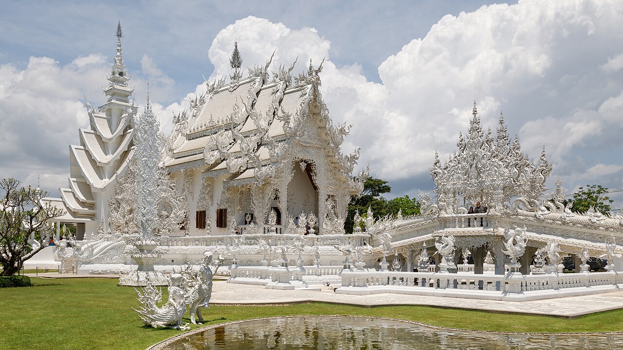 Wide shot: Wat Rong Khun, the White Temple, with its mirrored glass detail