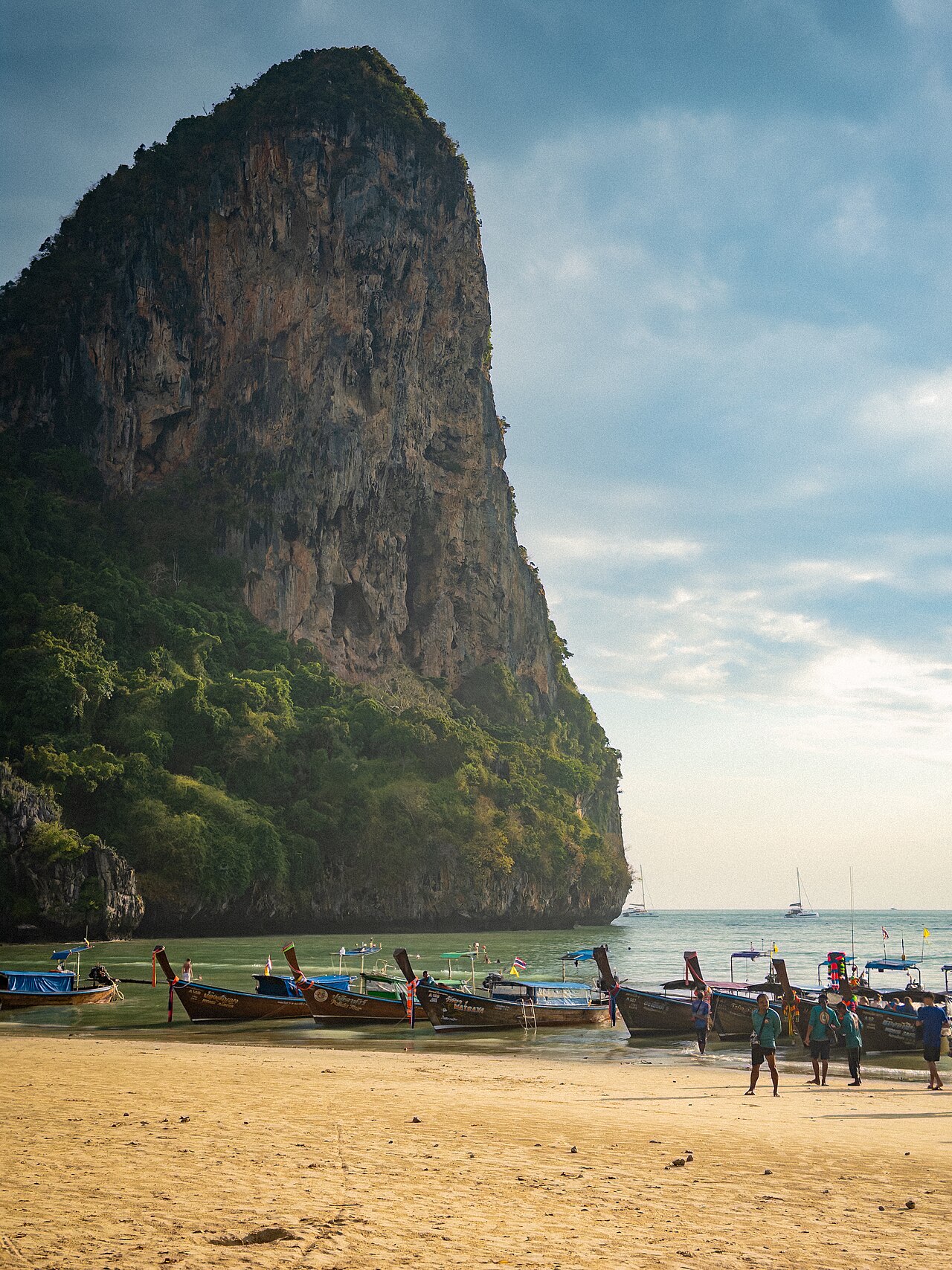 Wide shot: limestone karsts rising from the sea near Railay
